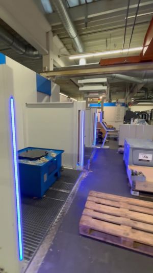 Modern Industrial Workshop Area With Equipment and Blue Neon Lighting