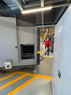 Worker Using Industrial Equipment in a Modern Factory Setting