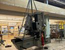 Industrial Machinery Being Hoisted with a Pulley in a Workshop Setting
