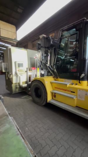 Yellow Forklift Operating in a Factory Setting Amid Industrial Equipment