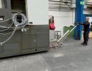 Worker Operates Machinery In Industrial Factory with Specialized Tools for Equipment Handling