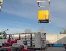 Construction Equipment Being Lifted by Crane at an Industrial Site