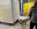 Worker Using Equipment in an Industrial Warehouse Setting during Heavy Freight Moving