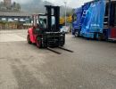 Red Forklift and Open Truck in Industrial Outdoor Setting