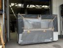 Large Wrapped Industrial Equipment Near Loading Dock of Warehouse Facility