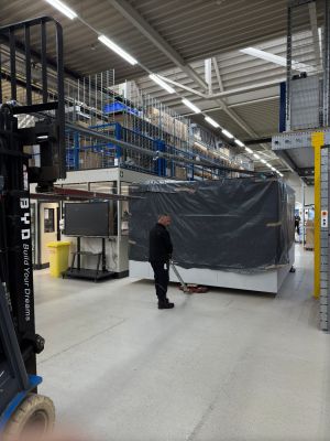 Worker Operating Jack in Spacious Industrial Warehouse Environment