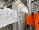 Industrial Equipment Inside a Factory With Metal Duct and Maintenance Documents
