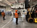 Industrial Workers Operating Machinery in a Mechanical Facility for Logistics