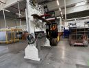 Industrial Warehouse Scene Featuring Machinery and Equipment with Worker Present