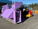 Forklift Transporting Large Purple Industrial Machine in Outdoor Factory Area