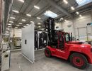 Industrial Forklift Operating in a Spacious Clean Warehouse with Large Equipment
