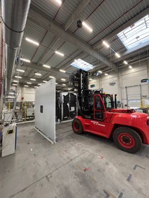 Industrial Forklift Operating in a Spacious Clean Warehouse with Large Equipment