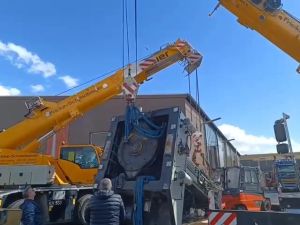 Large Industrial Equipment Being Lifted by Cranes at a Worksite