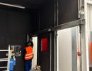 Arbeiter beim Einstellen des T&uuml;rrahmens in einer modernen industriellen Werkstattumgebung
